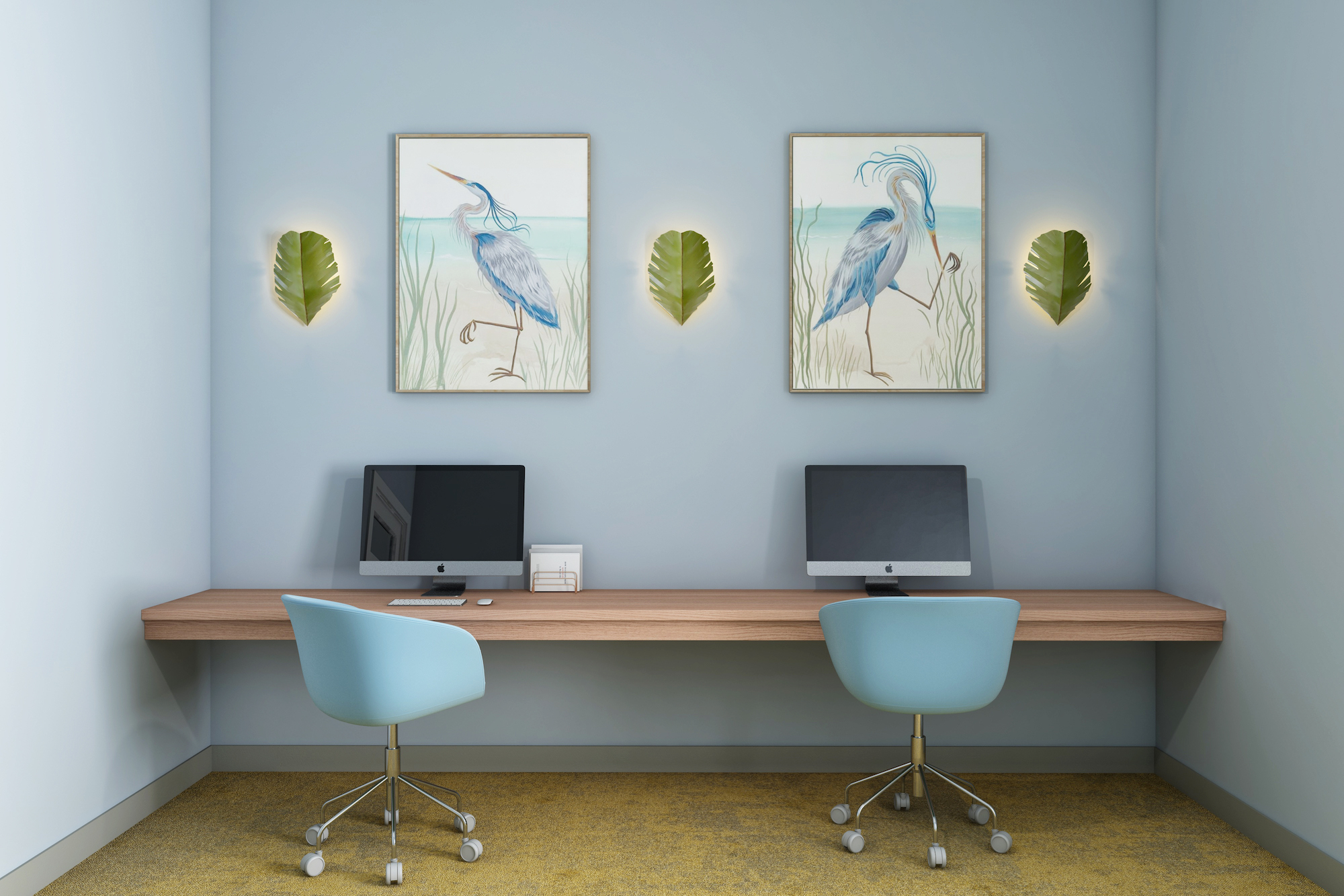 a desk with two computers and two pictures on the wall