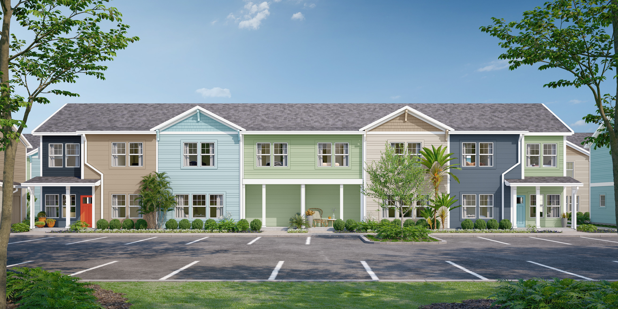 a row of multi-story houses with trees and grass