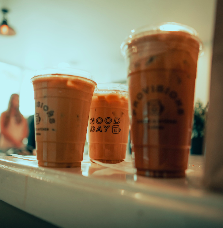 a group of plastic cups of iced coffee