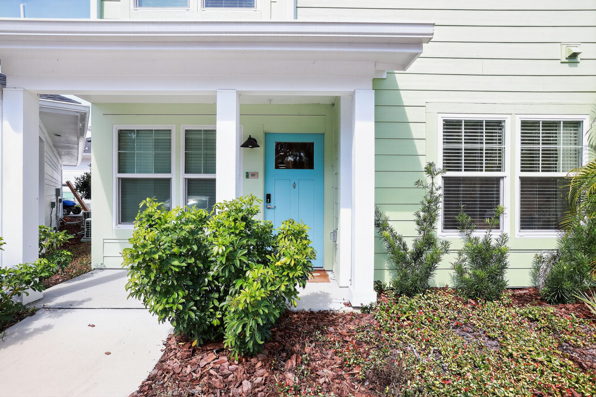 Charming house entrance with greenery.