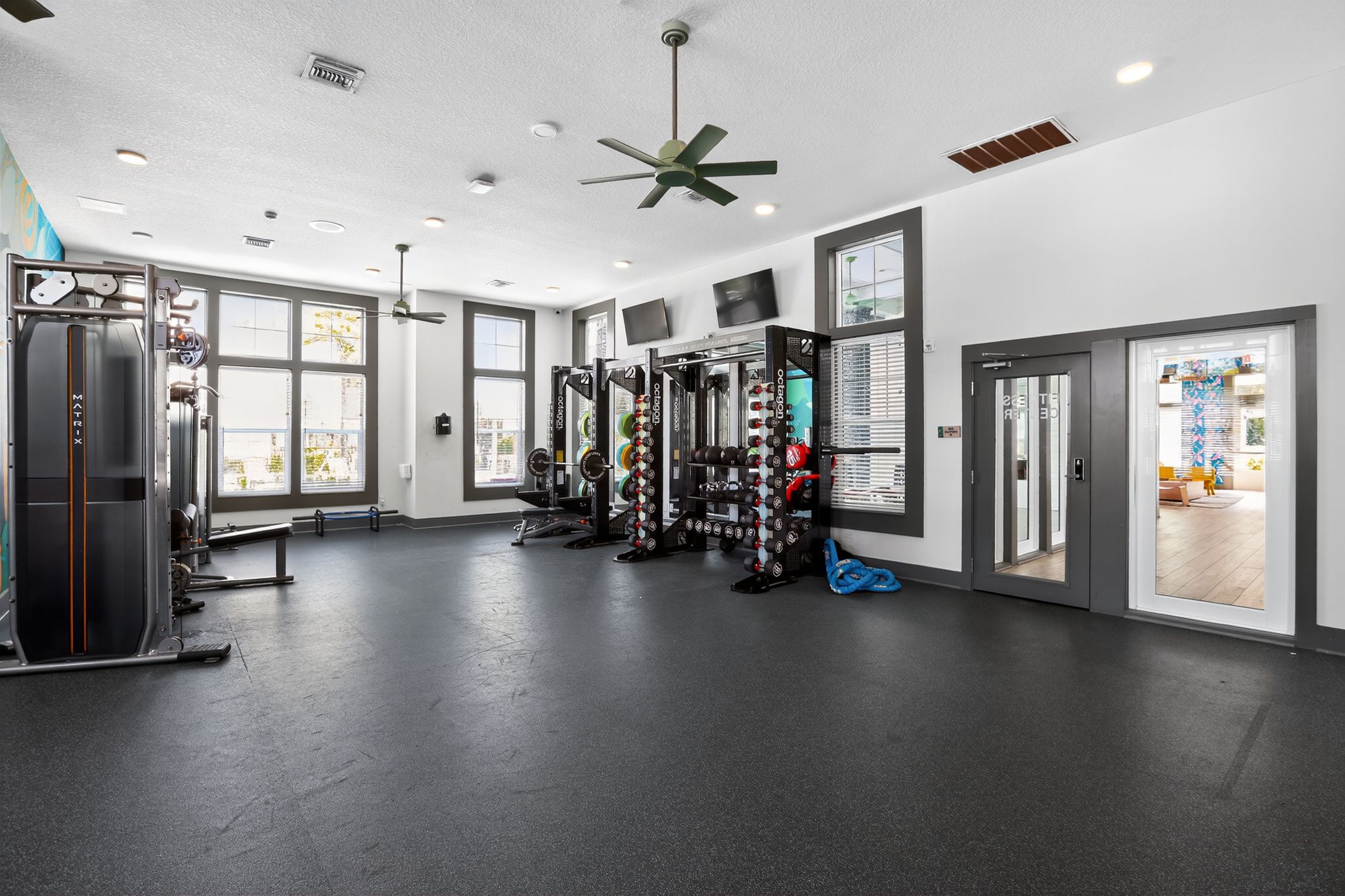 Modern gym with exercise equipment.